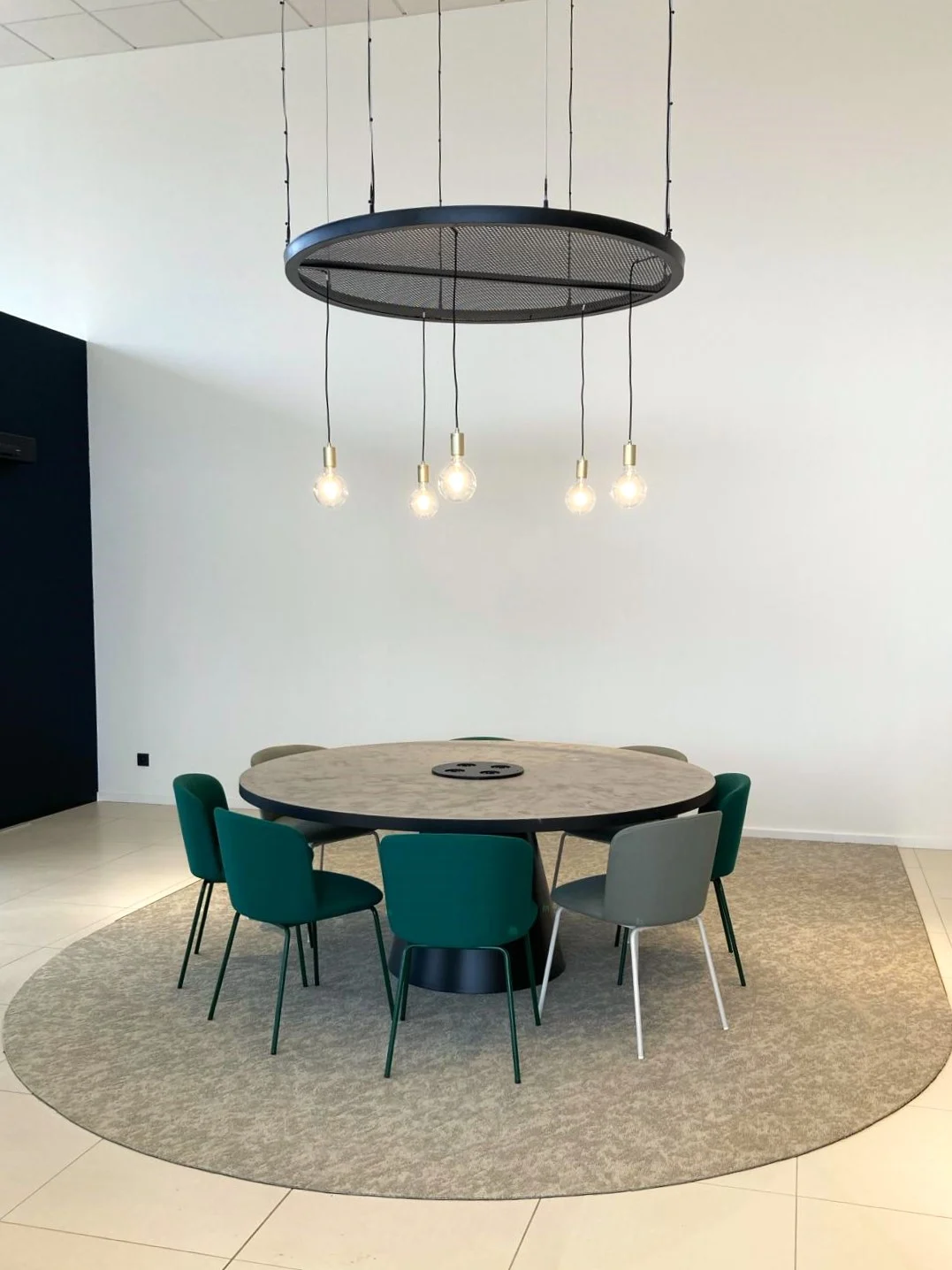 Round meeting room under a light pendant