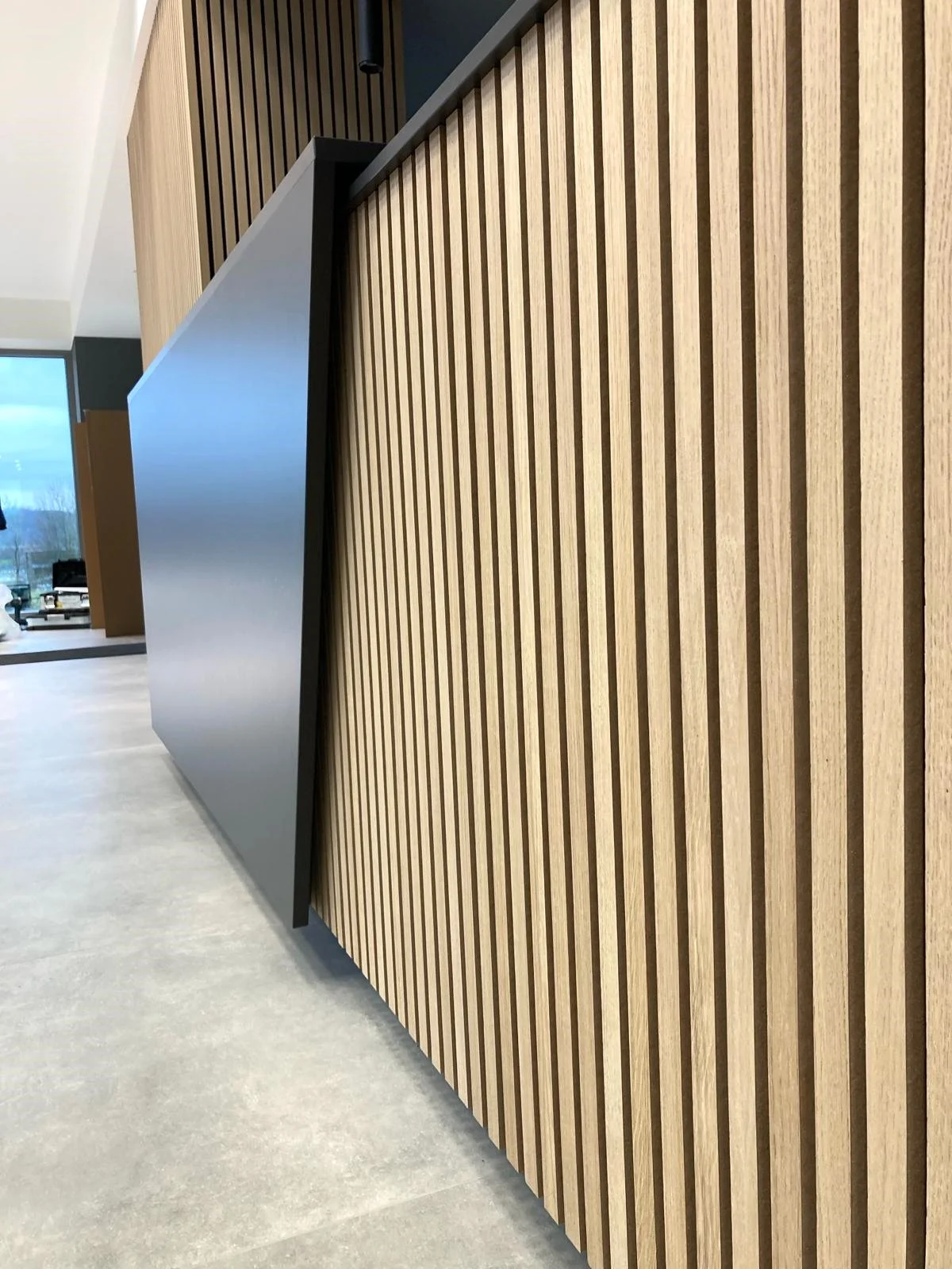 Bespoke reception desk clad in wooden slats