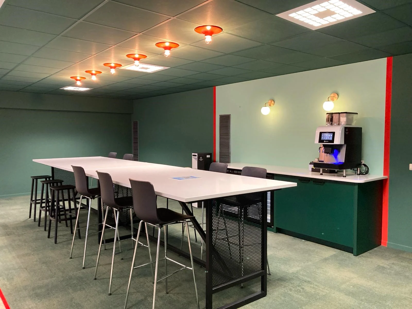 Cafeteria with green walls, standing tables and Infiniti high chairs