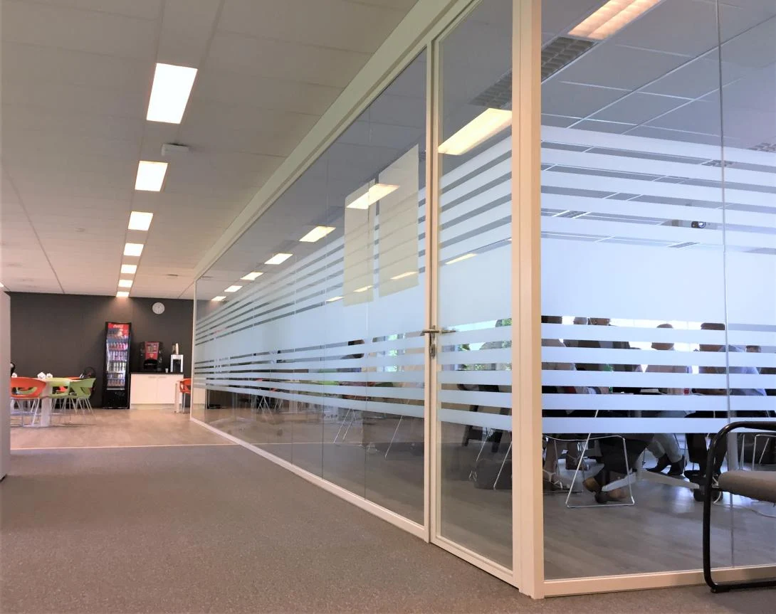 Glass partition with frosted bands along a corridor